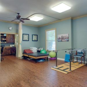 A well-equipped therapy room with exercise equipment for rehabilitation.