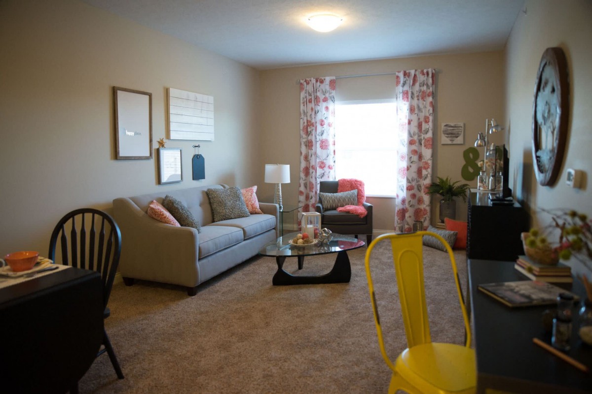 Cozy living room with modern decor and bright accents.