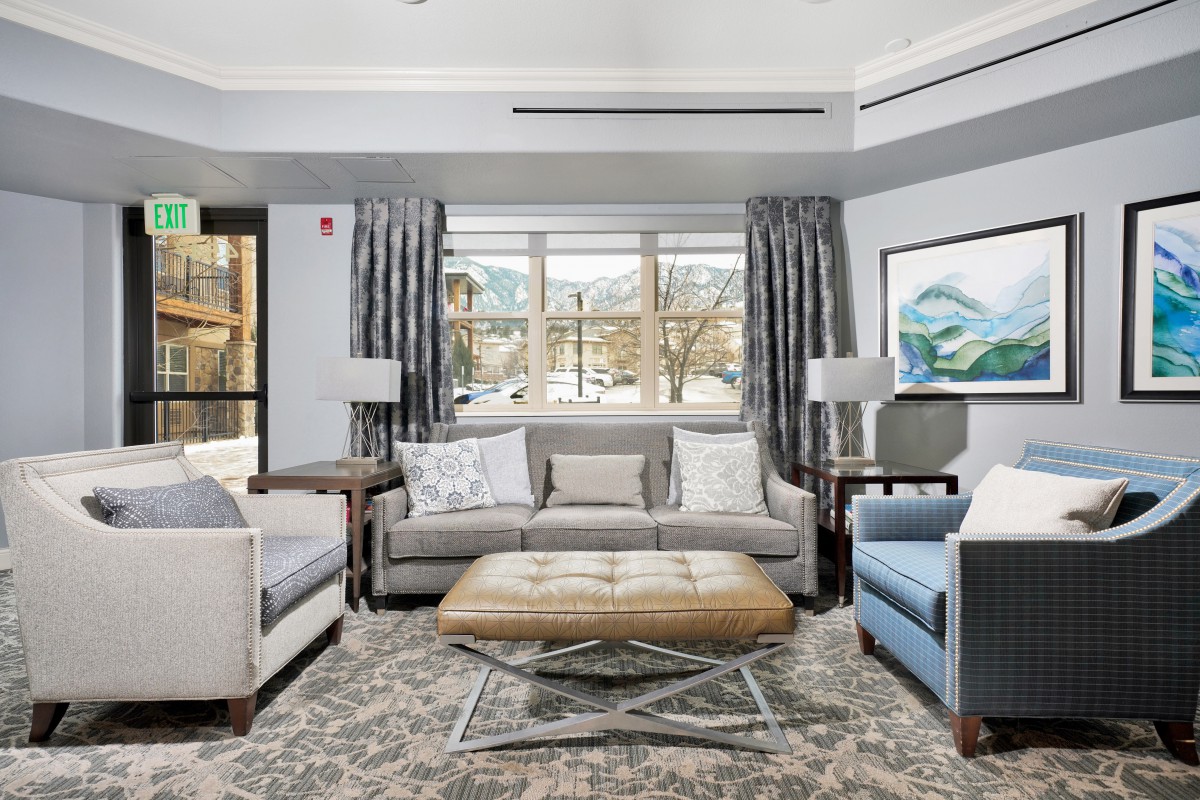 A modern living room featuring a comfortable sofa, stylish armchairs, and a coffee table in a well-lit space.