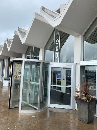A modern building entrance featuring a revolving door and a sleek architectural design.