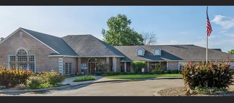 A suburban house with a wide driveway and well-maintained landscaping.