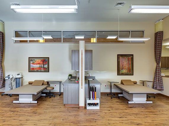 A modern physical therapy clinic with treatment beds and a welcoming environment.