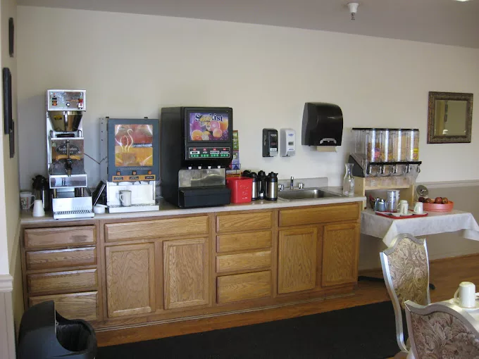 A self-service breakfast area featuring various drink dispensers and snack options.