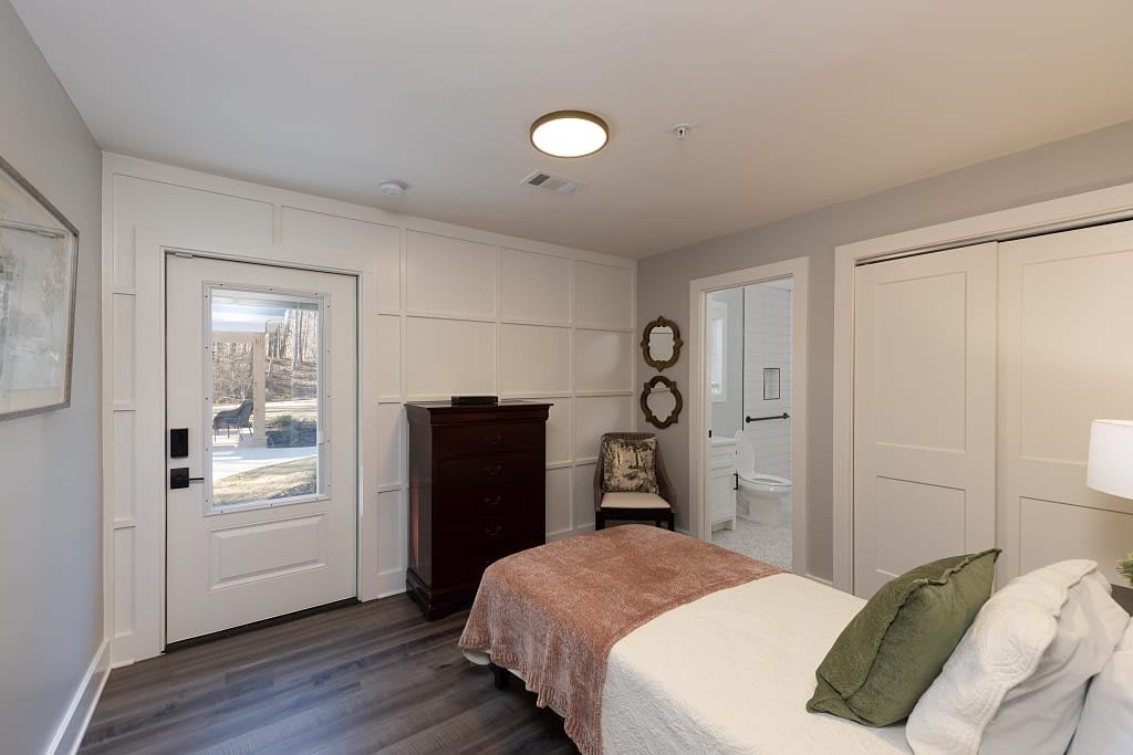 A cozy bedroom interior with modern furnishings and decor.