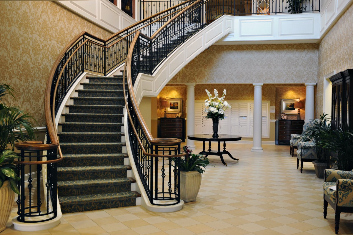 A luxurious lobby featuring a grand staircase and elegant decor.