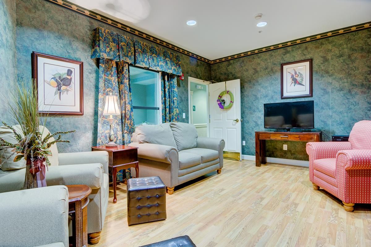 A cozy living room with a sofa, television, and decorative elements.
