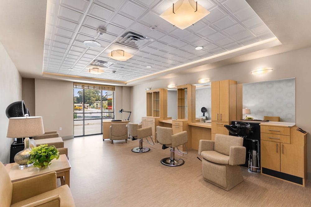 A modern salon interior with styling chairs and large mirrors.