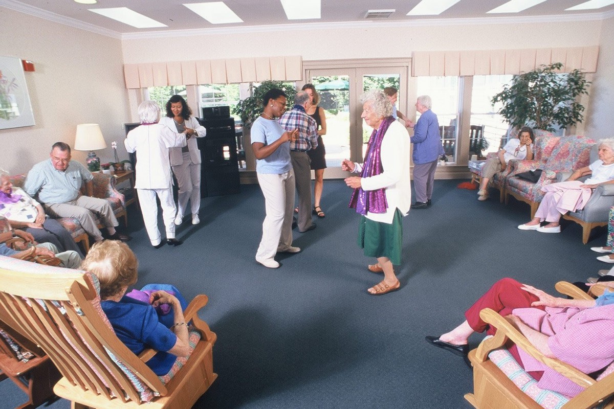 A group of elderly individuals enjoying a dance session at a senior center.