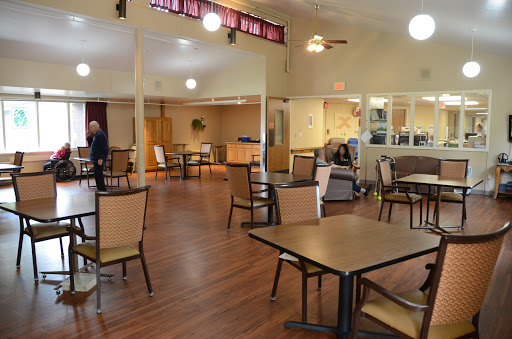 A spacious dining area with tables and chairs arranged for guests.