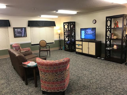 A cozy living room setup featuring comfortable seating and a television.