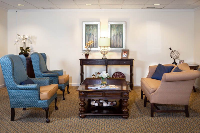 A cozy living room with elegant furniture and wall decor.