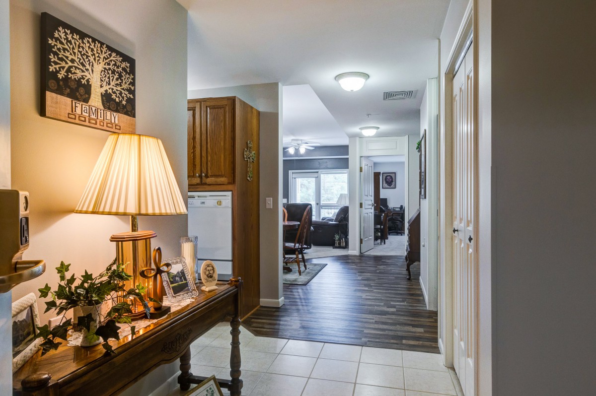 A cozy hallway leading to a living room with warm lighting and stylish decor.