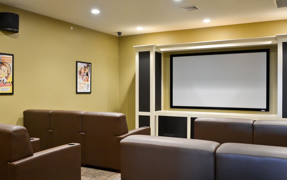 A cozy home theater setup featuring comfortable seating and a large screen.