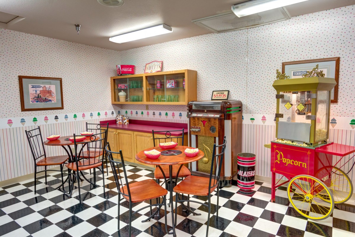 A retro-themed diner with checkered flooring and vintage furnishings.