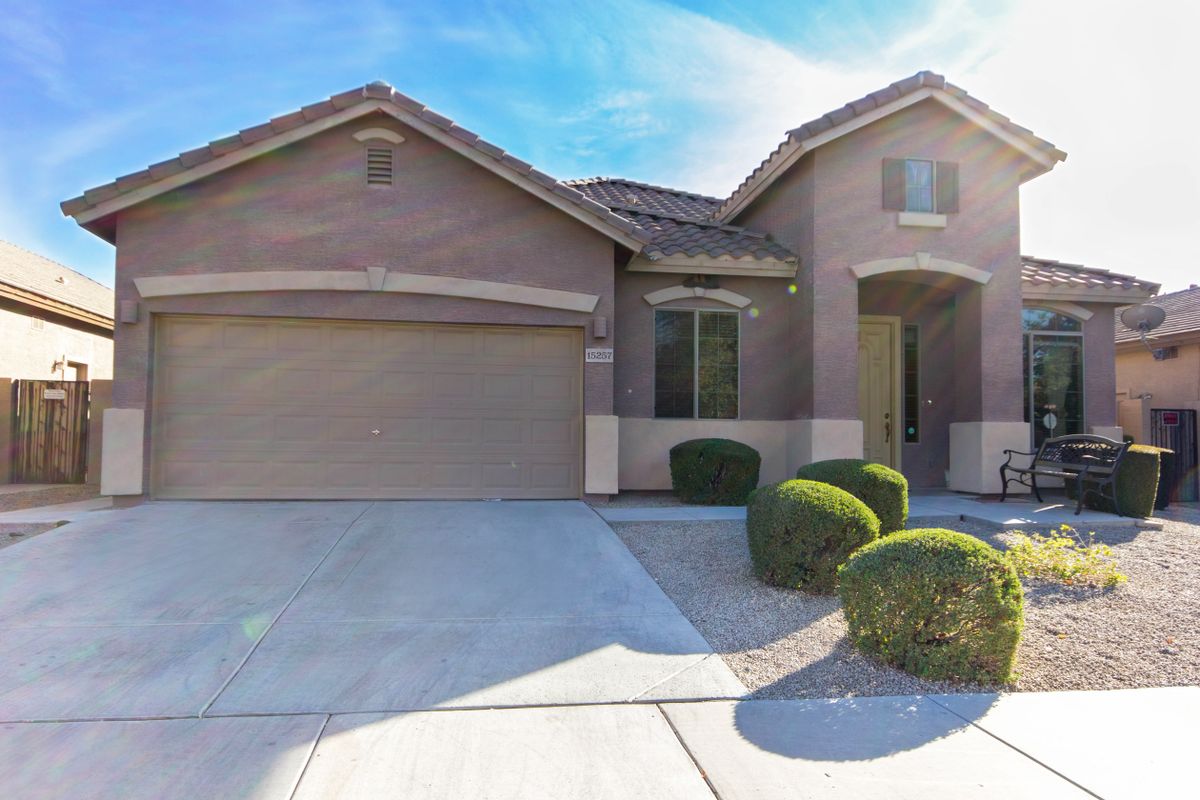 A suburban house with a two-car garage and well-maintained landscaping.