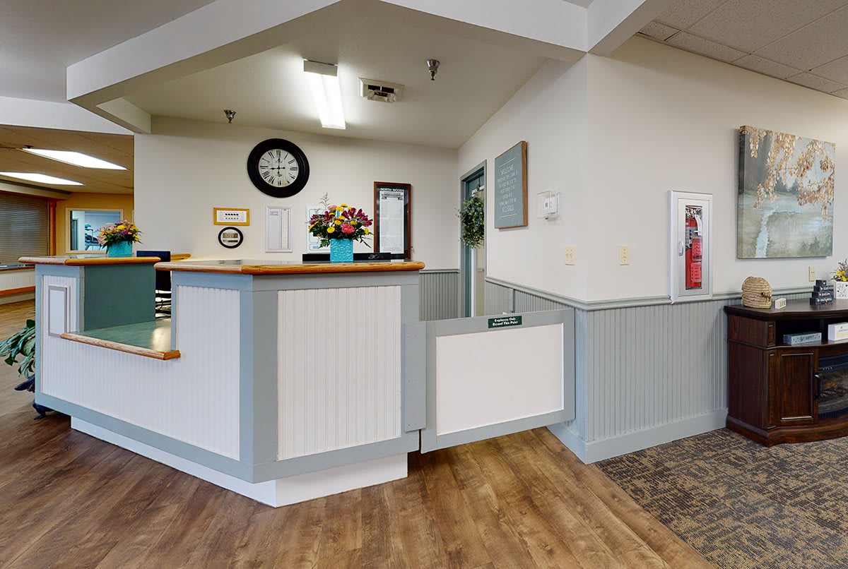 A welcoming reception area with a wooden countertop and decorative items.
