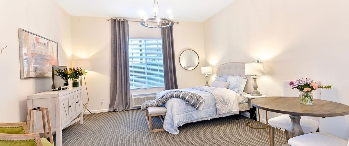 A modern and elegantly designed bedroom with soft lighting and neutral colors.