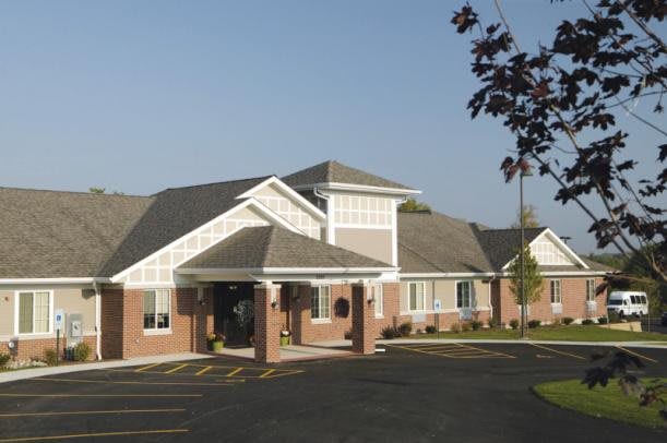 A suburban residential building with a neatly landscaped entrance.