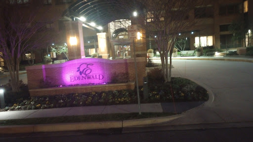 A night view of a building entrance with illuminated signage.