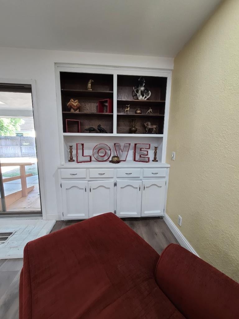 Cozy living room corner with a decorative bookshelf and LOVE sign.