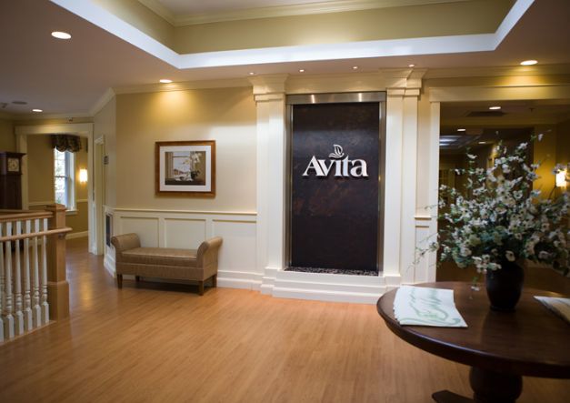 A welcoming lobby area with elegant decor and seating, featuring a prominent sign for Avila.