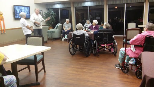 A musician performing for a group of senior citizens at a community center.