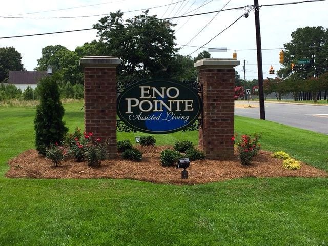 Entrance sign for Eno Pointe community surrounded by landscaped greenery.