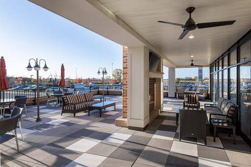 A stylish outdoor patio featuring comfortable seating and a welcoming atmosphere, perfect for enjoying sunny days.