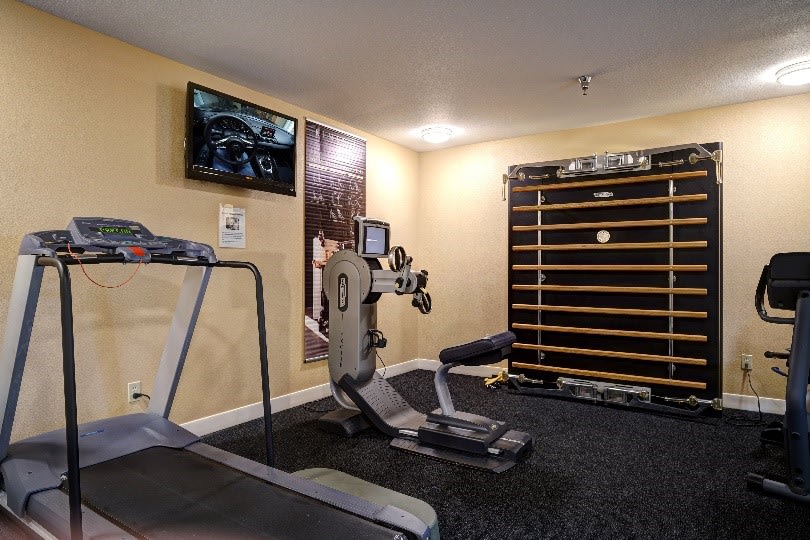 A well-equipped home gym featuring a treadmill and stationary bike, ideal for personal fitness routines.