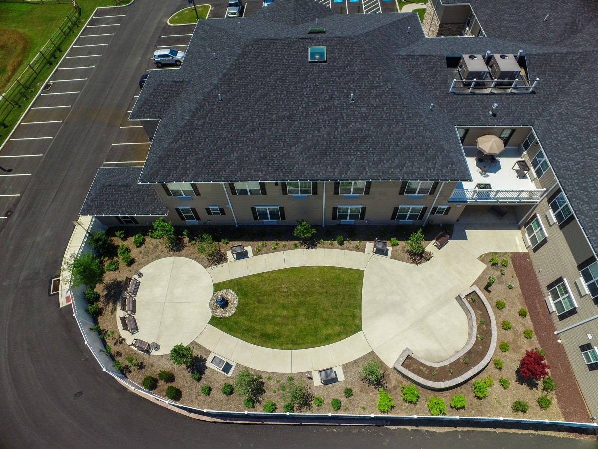 Aerial view of a building with landscaped gardens and pathways.