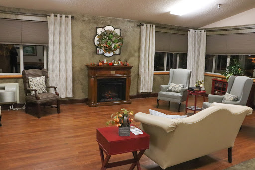 A cozy living room featuring a fireplace, comfortable seating, and tasteful decor.