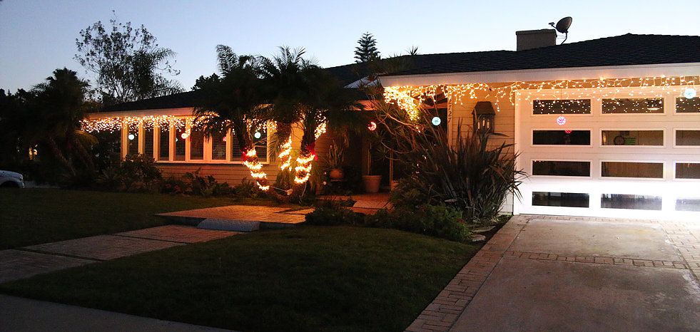 A house adorned with holiday lights in the evening.