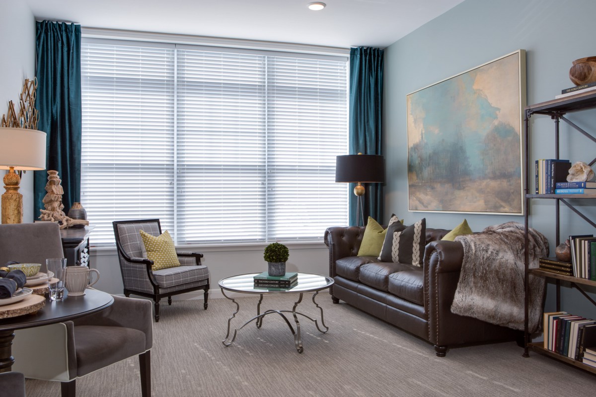 A stylish living room with modern furniture and large windows.