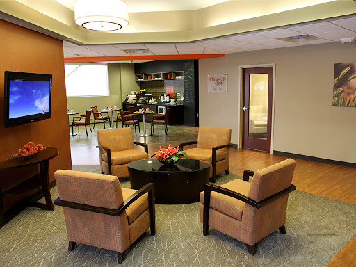 A cozy waiting area featuring comfortable seating and a modern aesthetic.