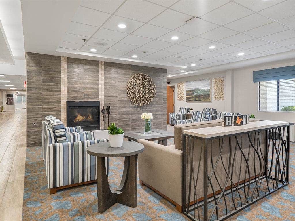 A modern lounge area with comfortable seating and a fireplace.
