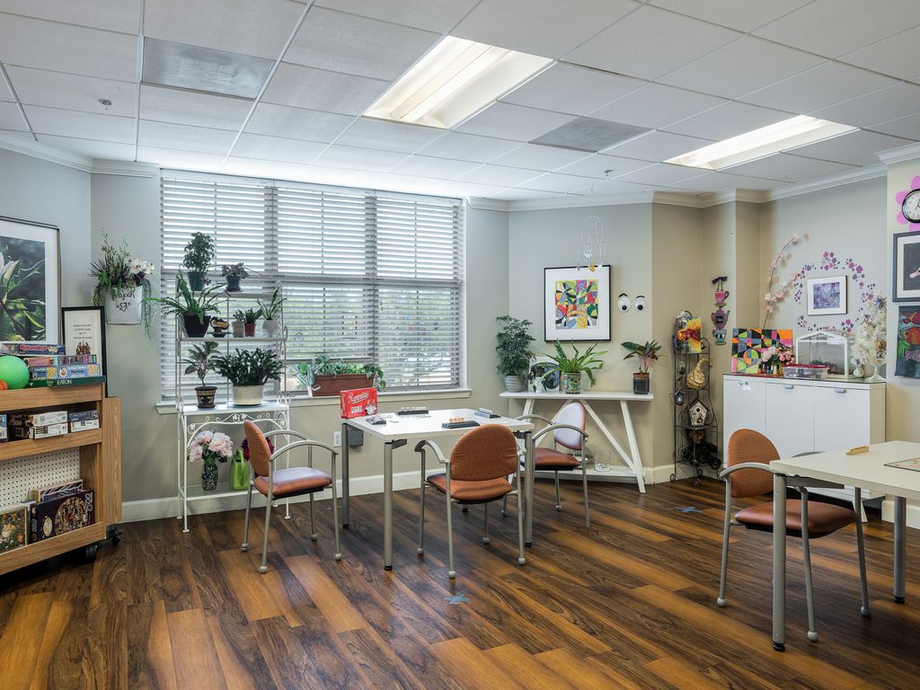 A modern office workspace with plants and natural lighting.