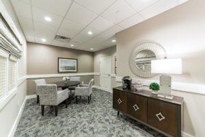 A well-furnished meeting room with seating and decorative elements.