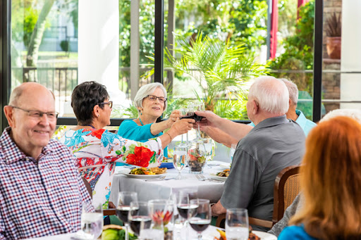 A joyful gathering of friends enjoying dinner and toasting to cherished moments.