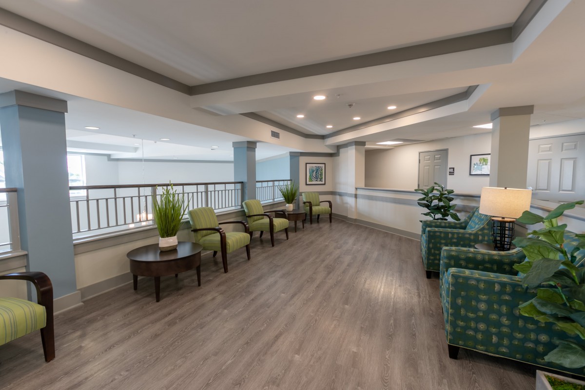 A modern lobby with seating areas and indoor plants.
