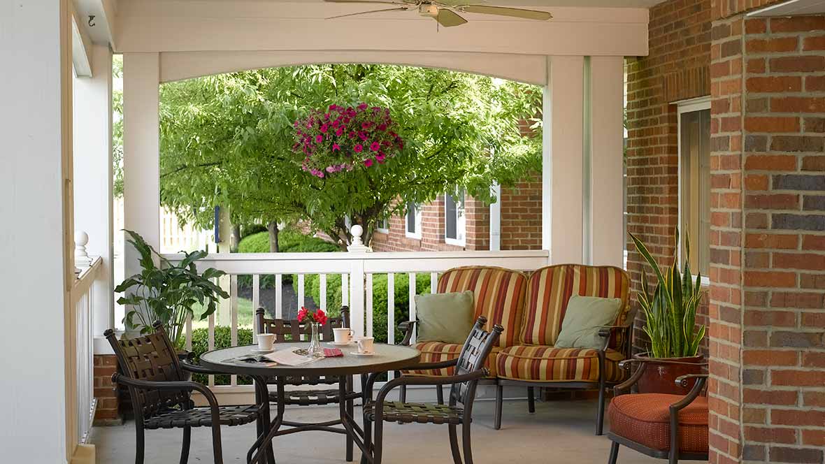 A cozy patio with comfortable seating and a garden view, perfect for relaxation.