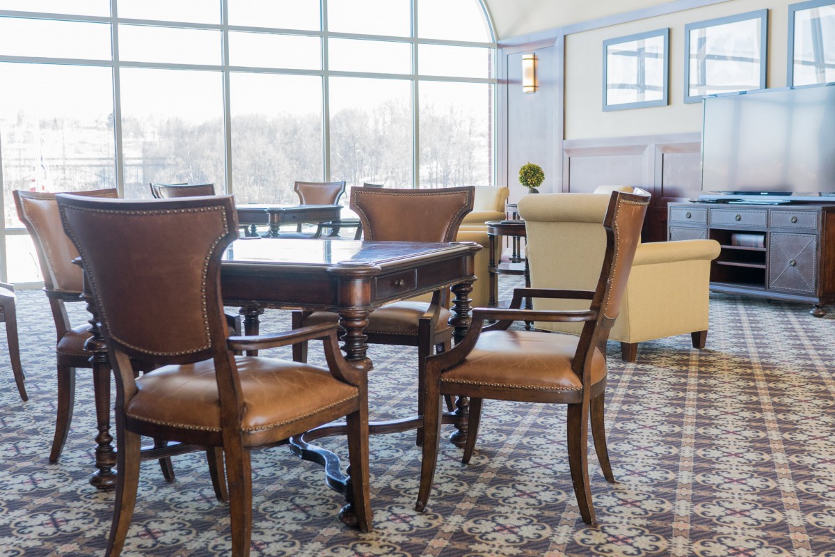Spacious lounge area with elegant furniture and large windows.