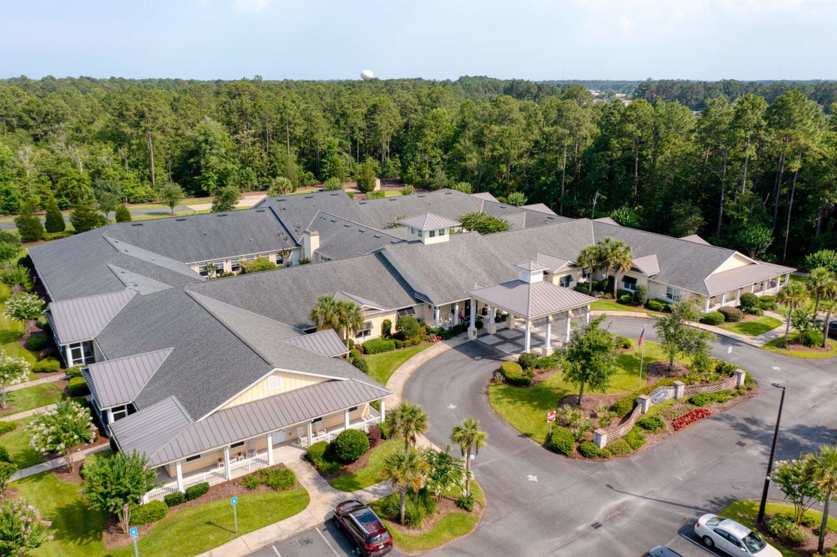 Aerial view of a large building surrounded by lush greenery.