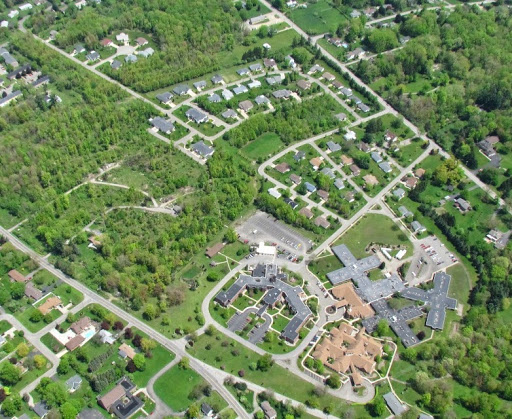 Aerial view of a suburban neighborhood surrounded by greenery.