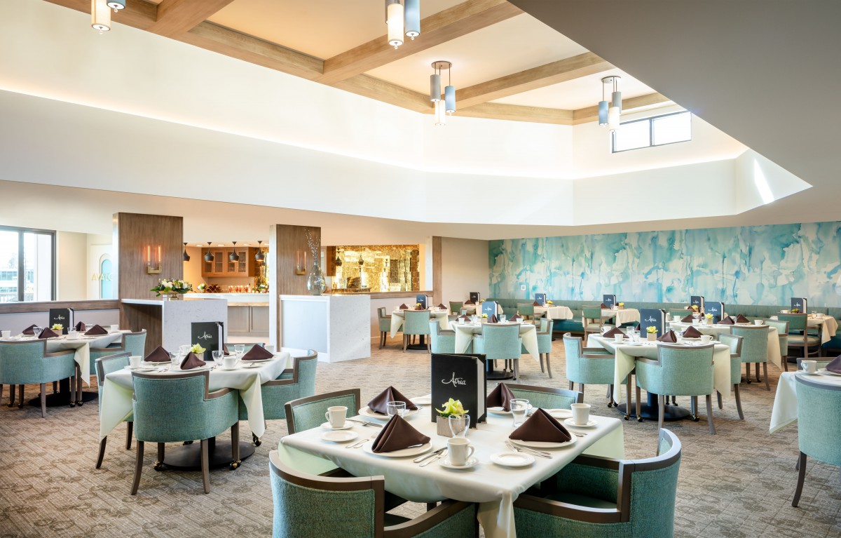 An elegantly designed restaurant dining area with neatly arranged tables and chairs.