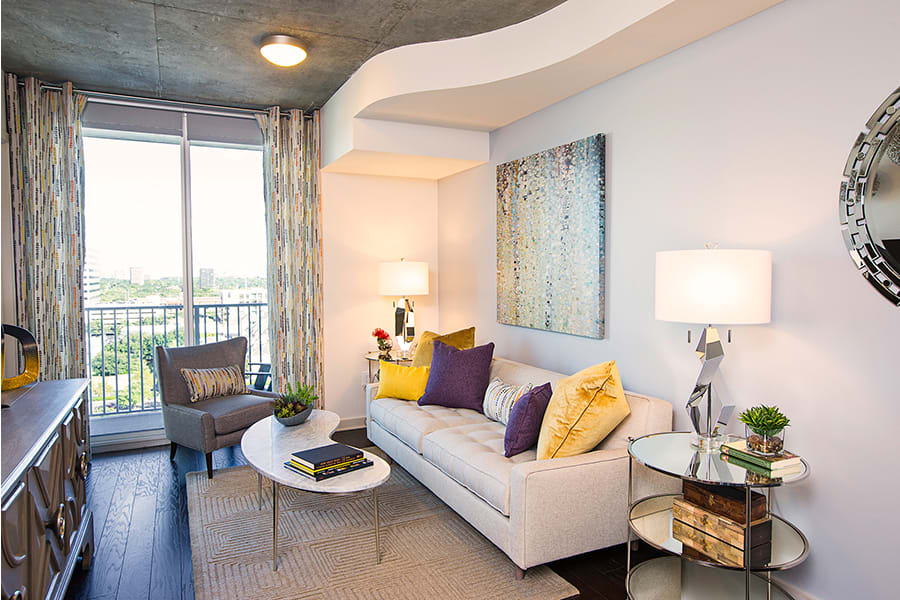 A modern living room with colorful pillows and contemporary decor.