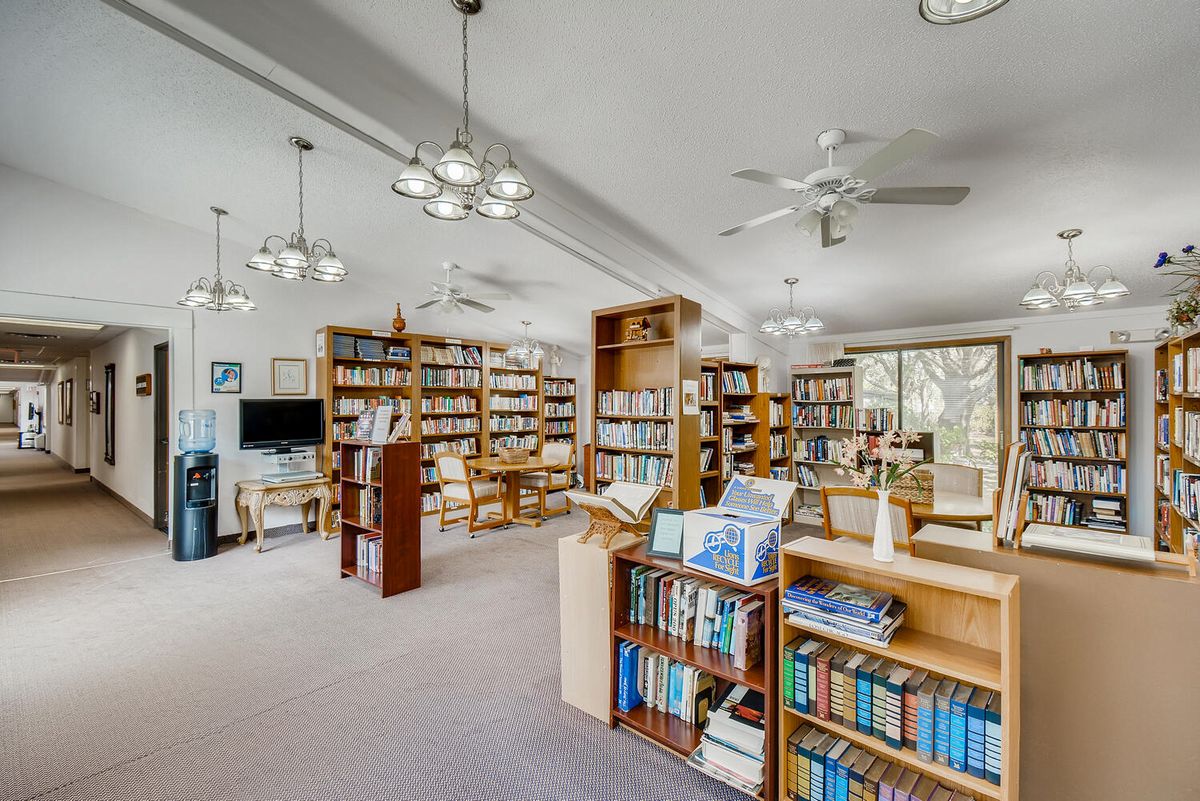 A spacious library with bookshelves and a comfortable reading area.