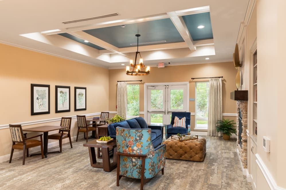 A modern living room with stylish furnishings and a chandelier.