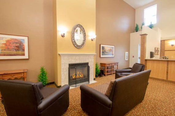 A cozy living room with a fireplace and comfortable seating.