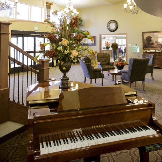 A welcoming lobby area featuring a grand piano and elegant decor.