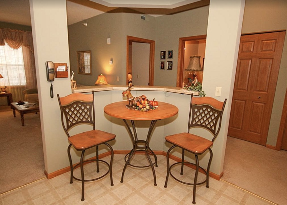 Cozy kitchen nook with a round table and two bar stools.